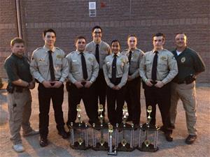 Explorer officers standing around five trophies that are sitting on the ground